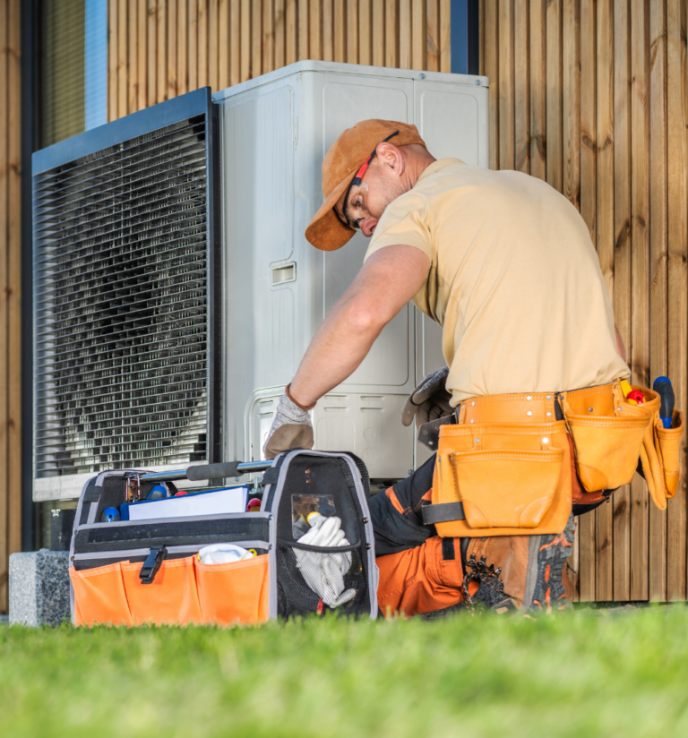 A technician repairs an air conditioner, focused on ensuring optimal performance and efficiency.
